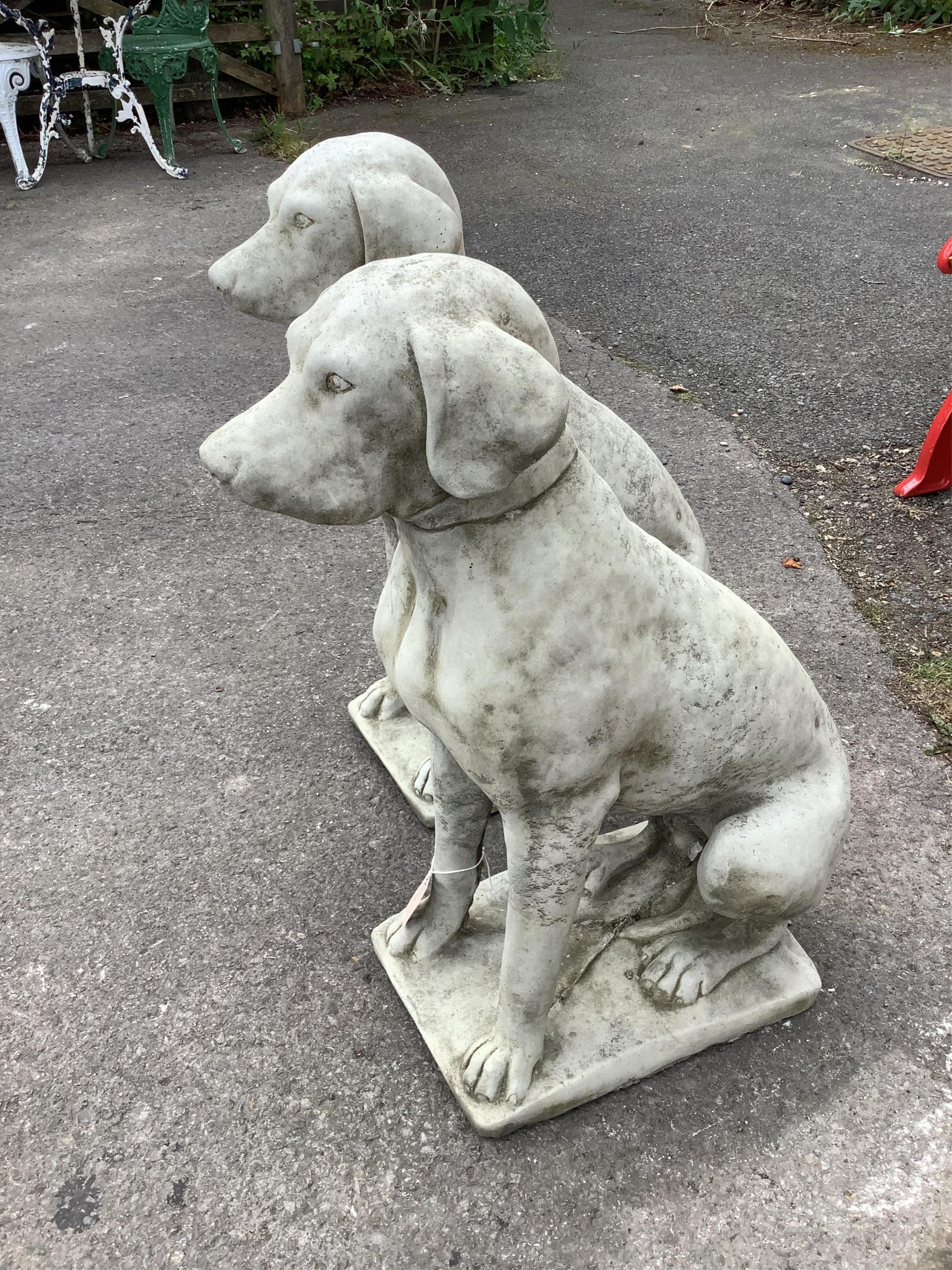 A pair of reconstituted stone seated hound garden ornaments, height 70cm. Condition - good